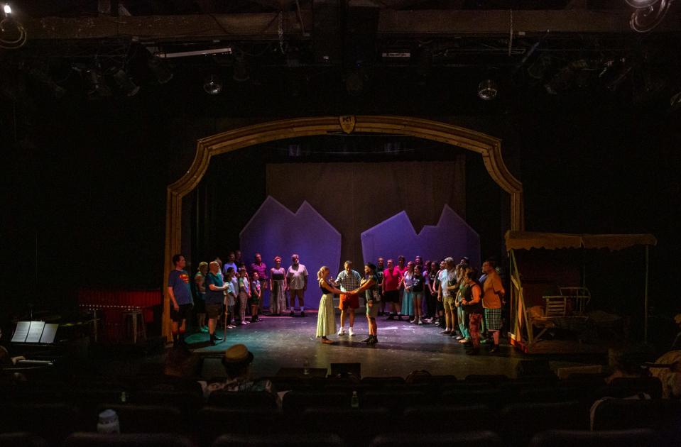 Brandy Valentine as Jean MacLaren and LT Cousineau as Charlie Dalrymple are surrounded by fellow cast members during a wedding scene during a rehearsal for "Brigadoon" at the Palm Canyon Theatre in Palm Springs, Calif., Saturday, Sept. 9, 2023.