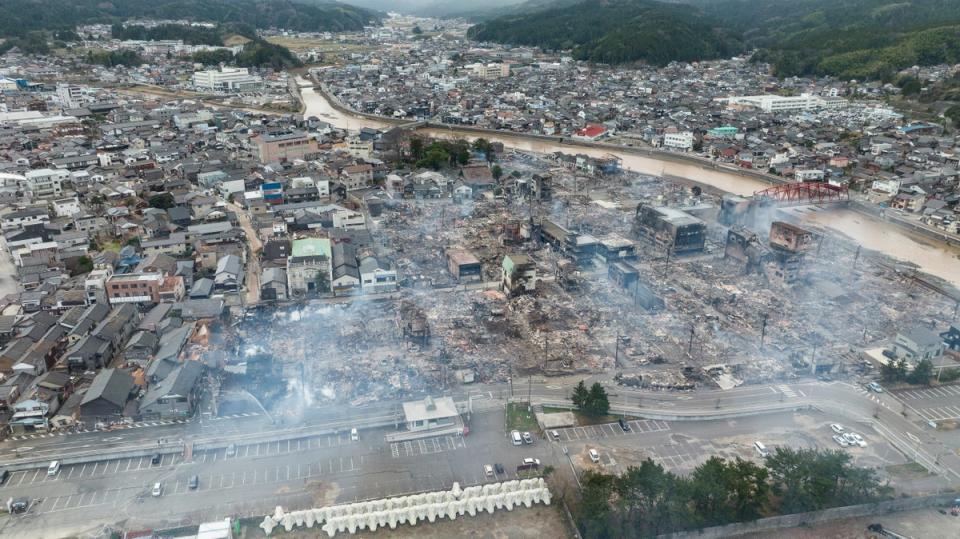 This aerial photo shows smoke rising from an area following a large fire in Wajima, Ishikawa prefecture (AFP via Getty Images)