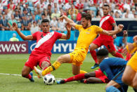 <p>Australia’s Mathew Leckie in action with Peru’s Anderson Santamaria and Christian Ramos </p>