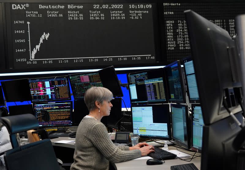 FILE PHOTO: A trader works at the Frankfurt stock exchange in Frankfurt