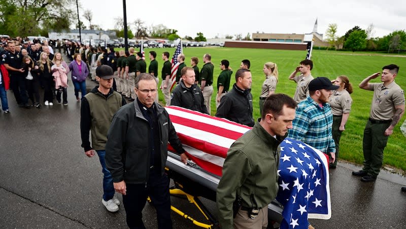The casket of fallen Santaquin officer Sgt. Bill Hooser is brought out of the state medical examiner’s office in Taylorsville and brought back to Santaquin on Monday, May 6, 2024.