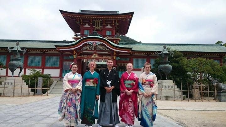 Monroe students visited a temple in Japan and wore traditional kimonos during a past trip to Hofu.