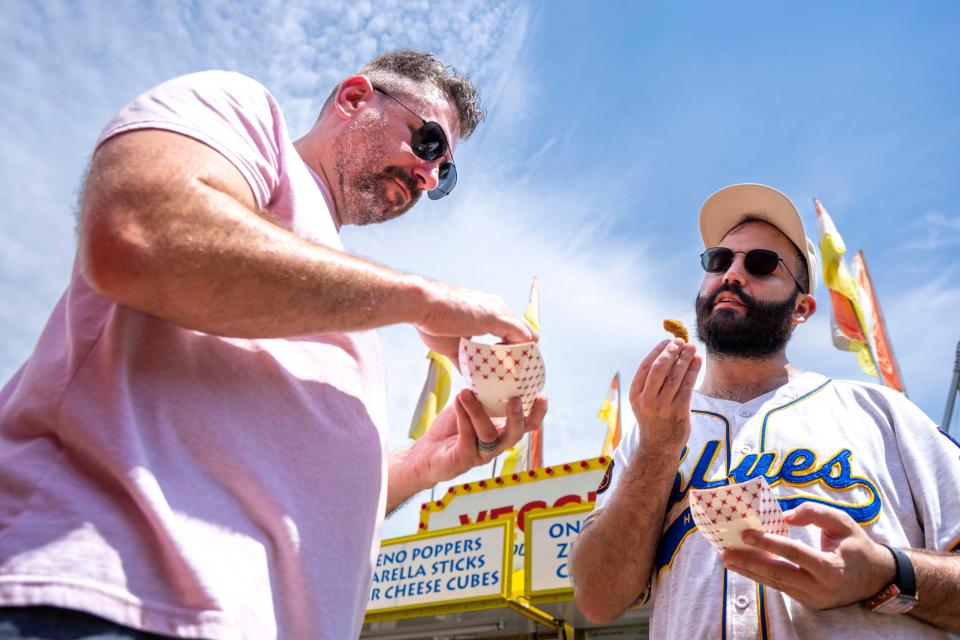 Professional chefs Alex Carter, owner of Black Cat Ice Cream, and Rateb Aburas, executive chef of Mulberry Street Tavern and the Surety Hotel Des Moines, taste the fried avocado from The Veggie Table at the Iowa State Fair.