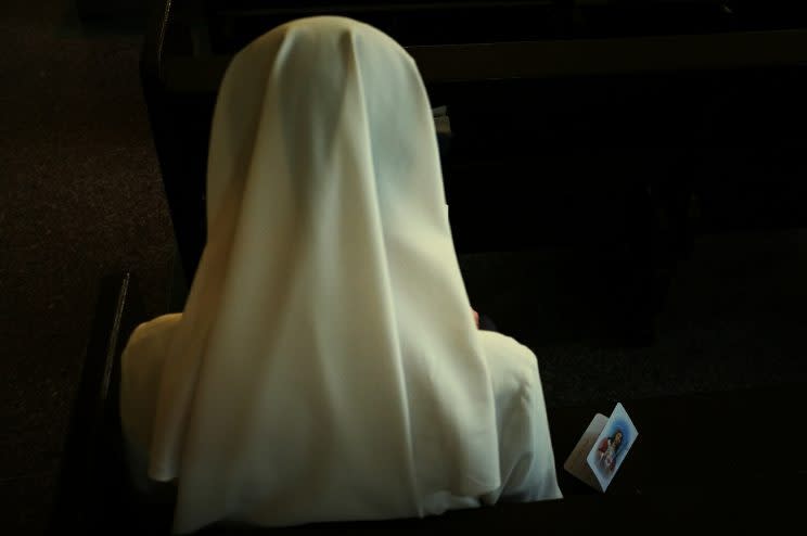 A nun prays in church. (Photo: Getty)