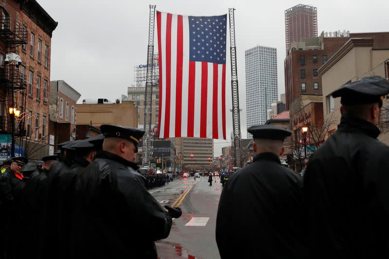 Police officers gather on street ahead of funeral service for Jersey City Police Detective Joseph Seals in Jersey City