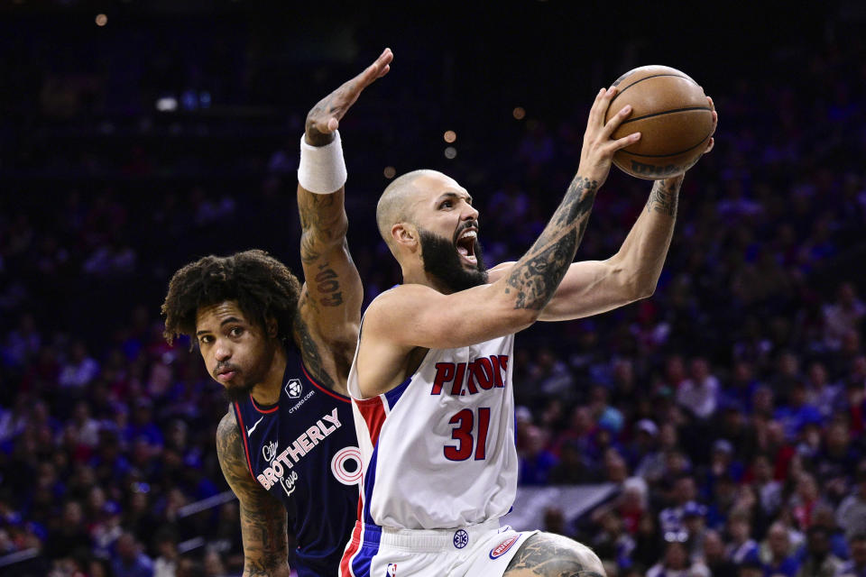 Detroit Pistons' Evan Fournier (31) goes up for a shot past Philadelphia 76ers' Kelly Oubre Jr. (9) during the second half of an NBA basketball game, Tuesday, April 9, 2024, in Philadelphia. (AP Photo/Derik Hamilton)
