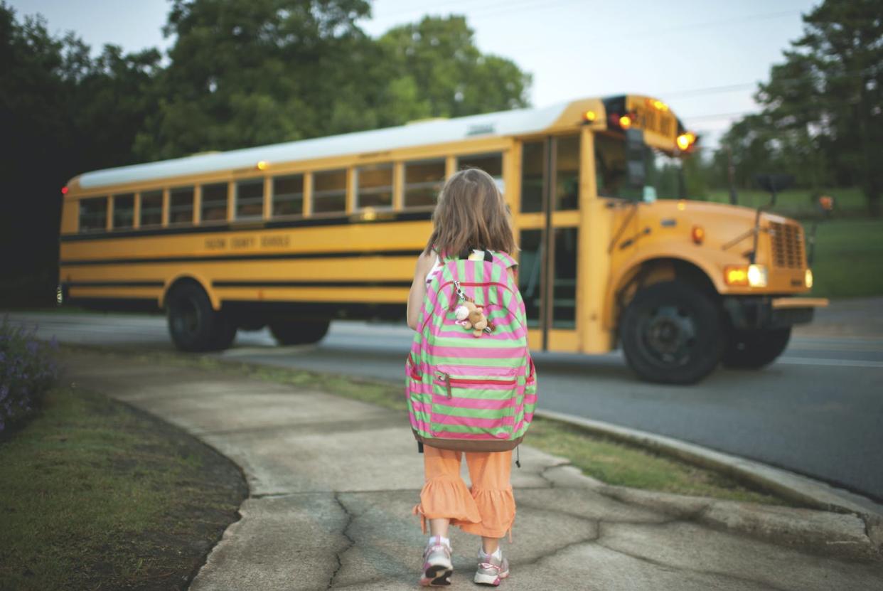 Predictable routines can help children feel calm and in control. <a href="https://www.gettyimages.com/detail/photo/rear-view-of-schoolgirl-with-backpack-waiting-for-royalty-free-image/1091290024" rel="nofollow noopener" target="_blank" data-ylk="slk:Cavan Images/Cavan Collection via Getty Images;elm:context_link;itc:0;sec:content-canvas" class="link ">Cavan Images/Cavan Collection via Getty Images</a>