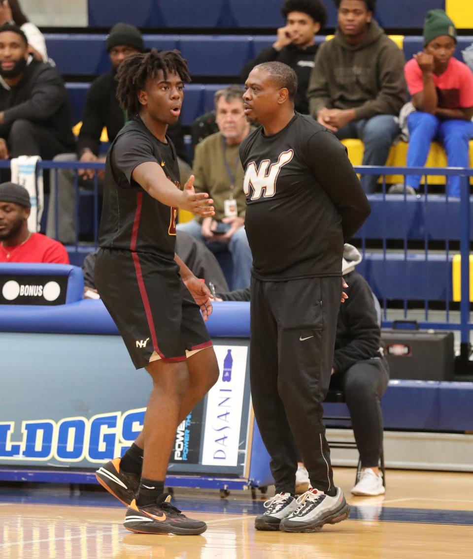 New Hampstead coach Jeffrey Williams talks with his son, AJ Williams after AJ was given a technical foul during the Savannah Holiday Classic on Friday, December 15, 2023 at Beach High School.