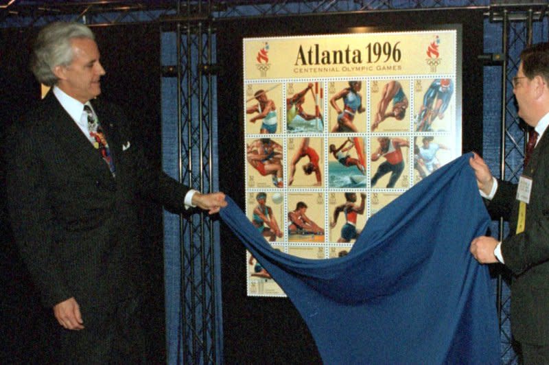 U.S. Postal CMO and Vice President Loren Smith (L) and Craig Tartasky, vice president and executive director Sports Division, E.J. Krausse & Associates, unveil the 1996 Olympic stamps February 1, 1996, in Atlanta. File Photo by Jim Middleton/UPI