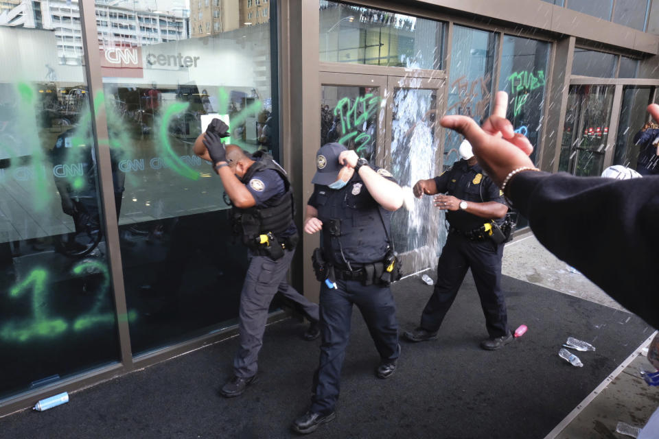 EDS NOTE: GRAPHIC CONTENT - Police react to protesters in Atlanta on May 29, 2020. Protesters carried signs and chanted their messages of outrage over the death of George Floyd in Minneapolis. (Ben Gray/Atlanta Journal-Constitution via AP)
