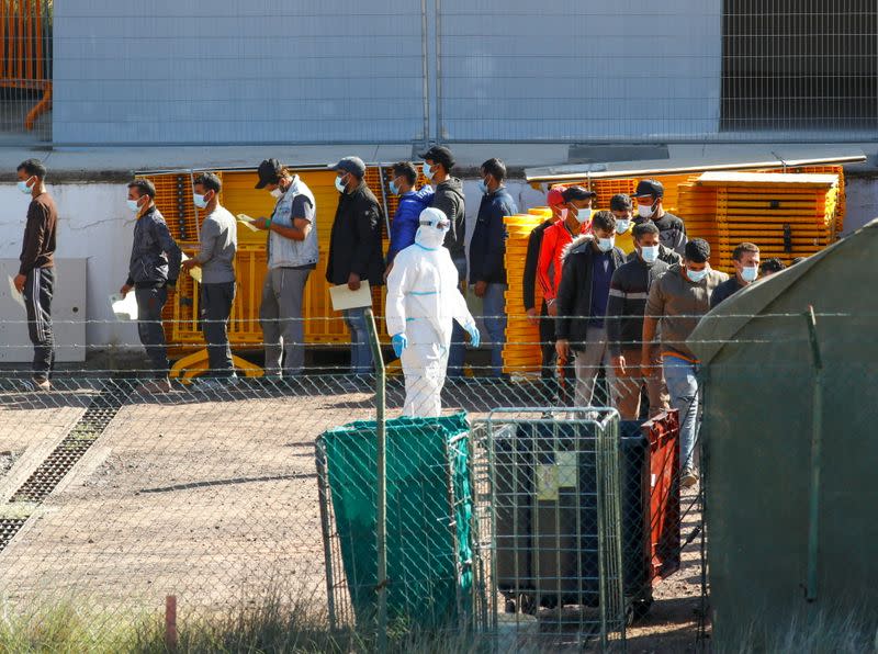 Migrants are seen in a military camp, where they are staying after being rescued by coast guards or reached the island by their own means, in Las Palmas