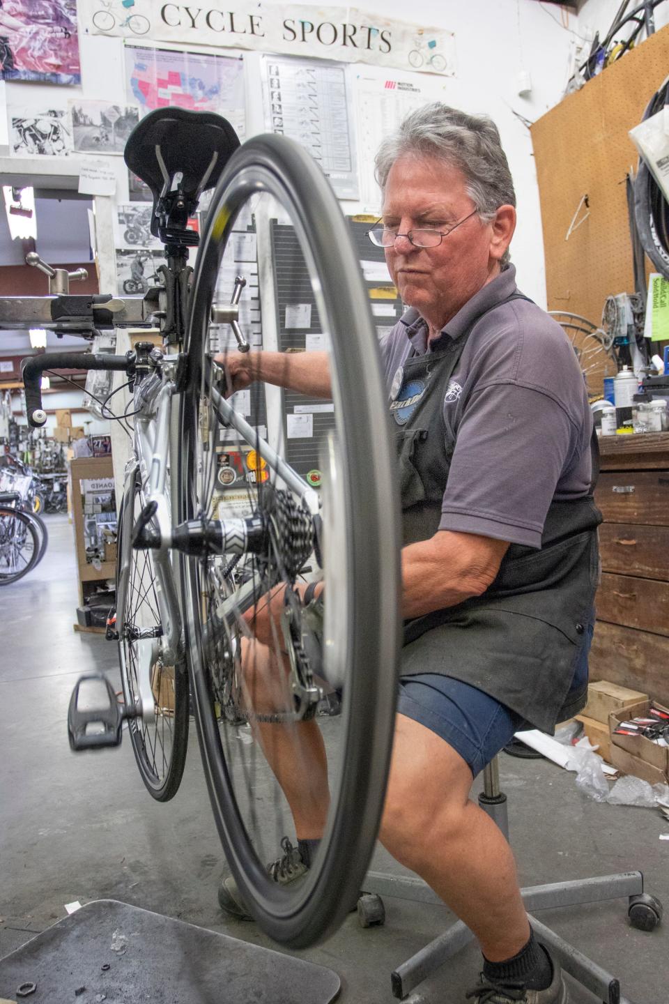 Coowner Tom Pilcher repairs a bike at CycleSports Bicycles on North Palafox Street in Pensacola on Tuesday, March 31, 2020.  The shop has seen an increase in business as people are biking more during the coronavirus pandemic.