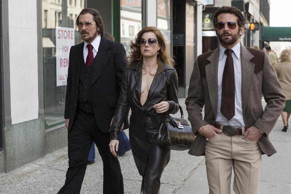 This photo released by Sony Pictures shows Christian Bale, left, as Irving Rosenfeld, Amy Adams as Sydney Prosser, and Bradley Cooper as Richie Dimaso in a scene from Columbia Pictures' film, "American Hustle." Two Oscar hopefuls expanded to nation-wide release and performed well during the busy weekend at the box office. David O. Russell’s Abscam film “American Hustle” earned $19 million. Disney’s making-of “Mary Poppins” tale “Saving Mr. Banks” took in $9.3 million in expansion. (AP Photo/Sony - Columbia Pictures, François Duhamel)