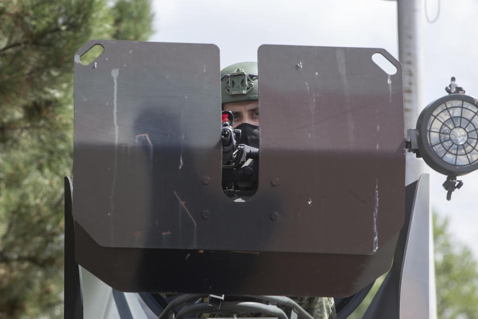 Kosovo Security Force soldier sits on top of armored Security vehicle donated by U.S during a handout ceremony in the military barracks Adem Jashari in capital Pristina on Monday, Aug. 30, 2021. U.S as the main suppliers of Kosovo's defense the U.S donated 55 armored security vehicles to Kosovo Army. (AP Photo/Visar Kryeziu)