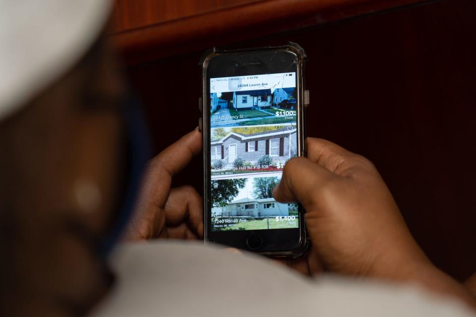 Quantanique Anderson of Detroit looks through housing listings while working with Macomb County Rotating Emergency Shelter Team (MCREST) case manager Kristin Lawrence to search for affordable housing through their program in Macomb County on July 26, 2021 at the MCREST building in Roseville.