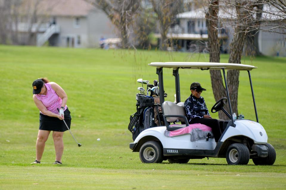 Clara Hooks waits in the golf cart as Marli Meiss drives from the rough on No. 5 during the Peoria Park District Spring Swing event Wednesday, April 10, 2024 at Kellogg Golf Course in Peoria.