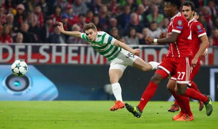 Soccer Football - Champions League - Bayern Munich vs Celtic - Allianz Arena, Munich, Germany - October 18, 2017 Celtic’s James Forrest has a shot at goal as Bayern Munich's David Alaba attempts to block REUTERS/Michael Dalder