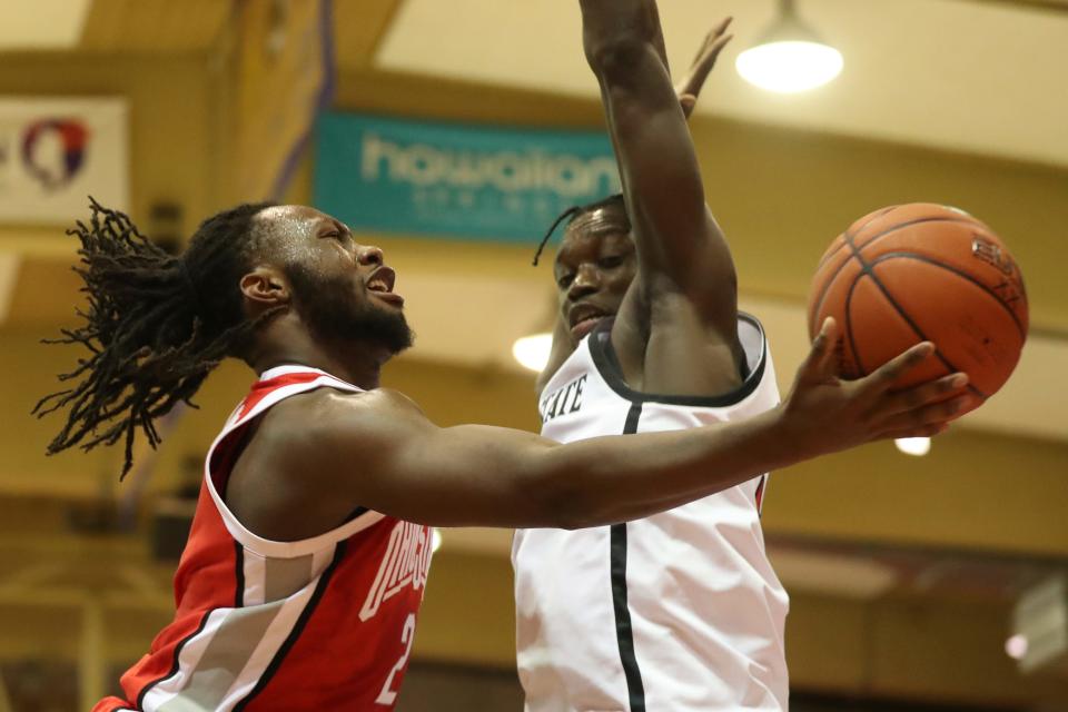 Ohio State guard Bruce Thornton (2) attempts to shoot under San Diego State forward Nathan Mensah, right, during the first half of an NCAA college basketball game, Monday, Nov. 21, 2022, in Lahaina, Hawaii. (AP Photo/Marco Garcia)