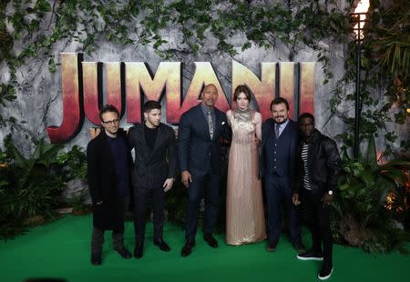 FILE PHOTO: Director Jake Kasdan and cast members Nick Jonas, Dwayne Johnson, Karen Gillan, Jack Black and Kevin Hart pose for photographers as they arrive for the UK premiere of 'Jumanji: Welcome to the Jungle', at the Vue West End, Leicester Square, central London, Britain December 7, 2017. REUTERS/Simon Dawson/Files