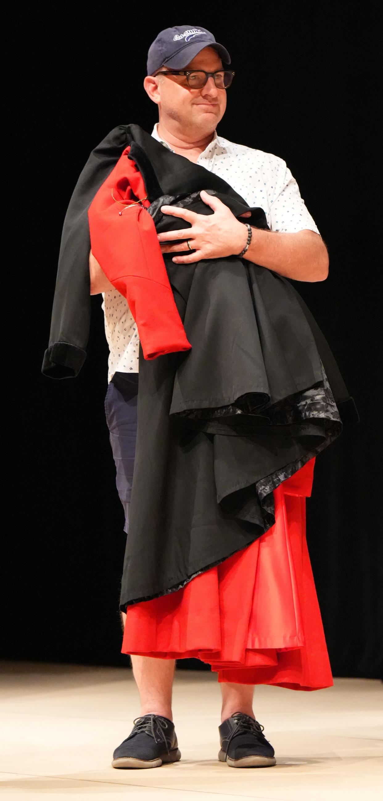 Jeffery Meek, Costume Director, holds the outfit for OU alumnus and Broadway star Adrianna Hicks, who is playing the title role in Lyric Theatre’s “Mary Poppins” June 25-30 at the Civic Center learns how to fly at rehearsal on June 18.