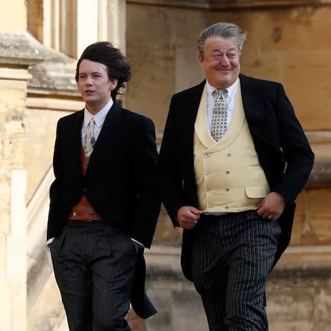 Stephen Fry, right, arrives with his husband Elliott Spencer  - Credit: Adrian Dennis/Pool via AP