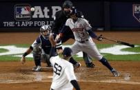 Oct 16, 2017; Bronx, NY, USA; Houston Astros center fielder Cameron Maybin (3) hits a single during the third inning against the New York Yankees during game three of the 2017 ALCS playoff baseball series at Yankee Stadium. Mandatory Credit: Adam Hunger-USA TODAY Sports