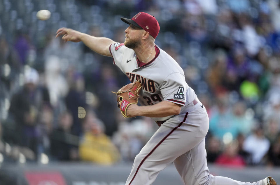 Arizona Diamondbacks starting pitcher Merrill Kelly works against the Colorado Rockies during the first inning of a baseball game Friday, April 28, 2023, in Denver. (AP Photo/David Zalubowski)