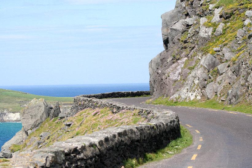 This May 29, 2012, photo shows the swerving road at the tip of the Dingle Peninsula in County Kerry, Ireland. Ireland is about 300 miles from north to south and a driving trip in the country's western region takes you along hilly, narrow roads with spectacular views ranging from seaside cliffs to verdant farmland. (AP Photo/Jake Coyle)