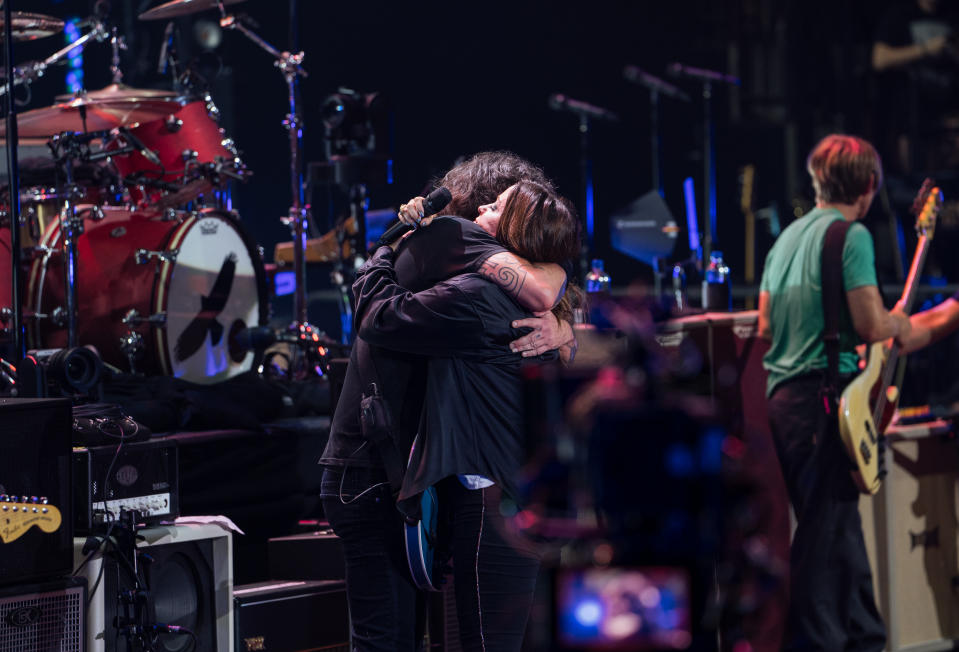 Dave Grohl and Alanis Morissette hug at the Taylor Hawkins tribute concert in Los Angeles