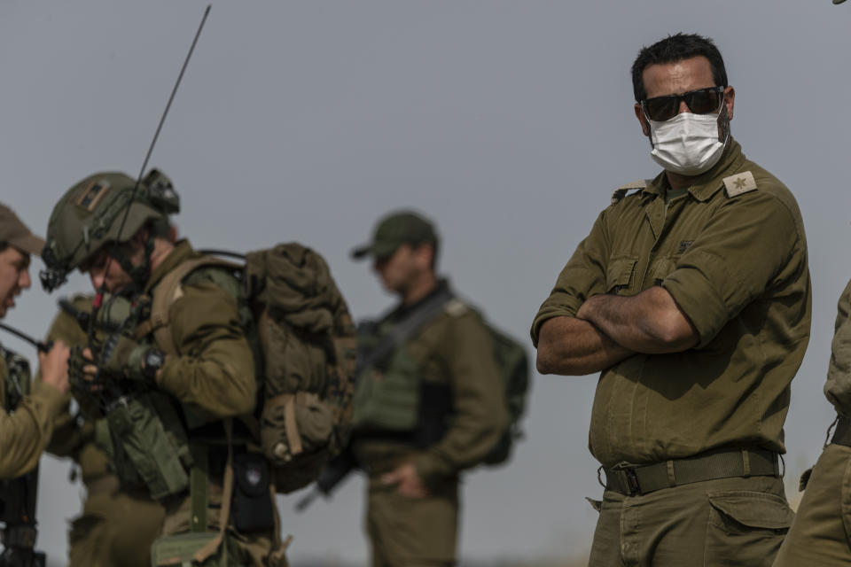 In this Wednesday, May 13, 2020 photo, Israeli troops take part in a drill in northern Israel. Twenty years after Hezbollah guerrillas pushed Israel’s last troops from southern Lebanon, both sides are gearing up for a war that neither seems to want. Israeli troops are drilling for a possible invasion of Lebanon and striking Hezbollah targets in neighboring Syria. Hezbollah is beefing up its own forces and threatening to invade Israel. (AP Photo/Tsafrir Abayov)