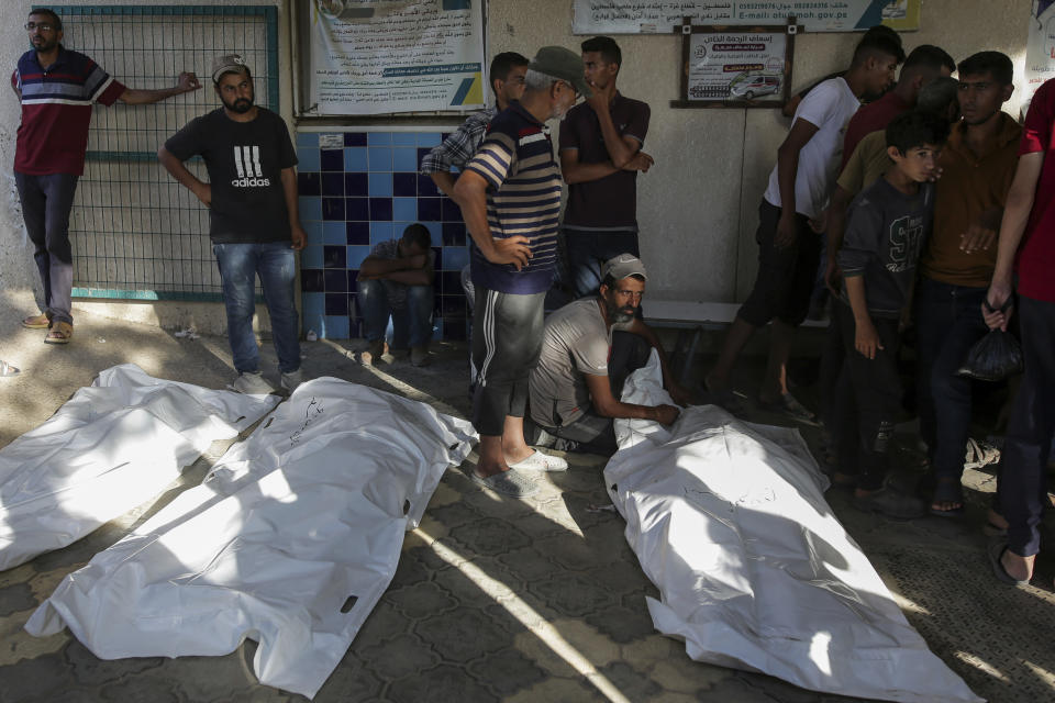 Palestinians mourn their relatives killed in the Israeli bombardment of the Gaza Strip at a hospital morgue in Khan Younis, southern Gaza Strip, Monday, June 24, 2024. (AP Photo/Jehad Alshrafi)