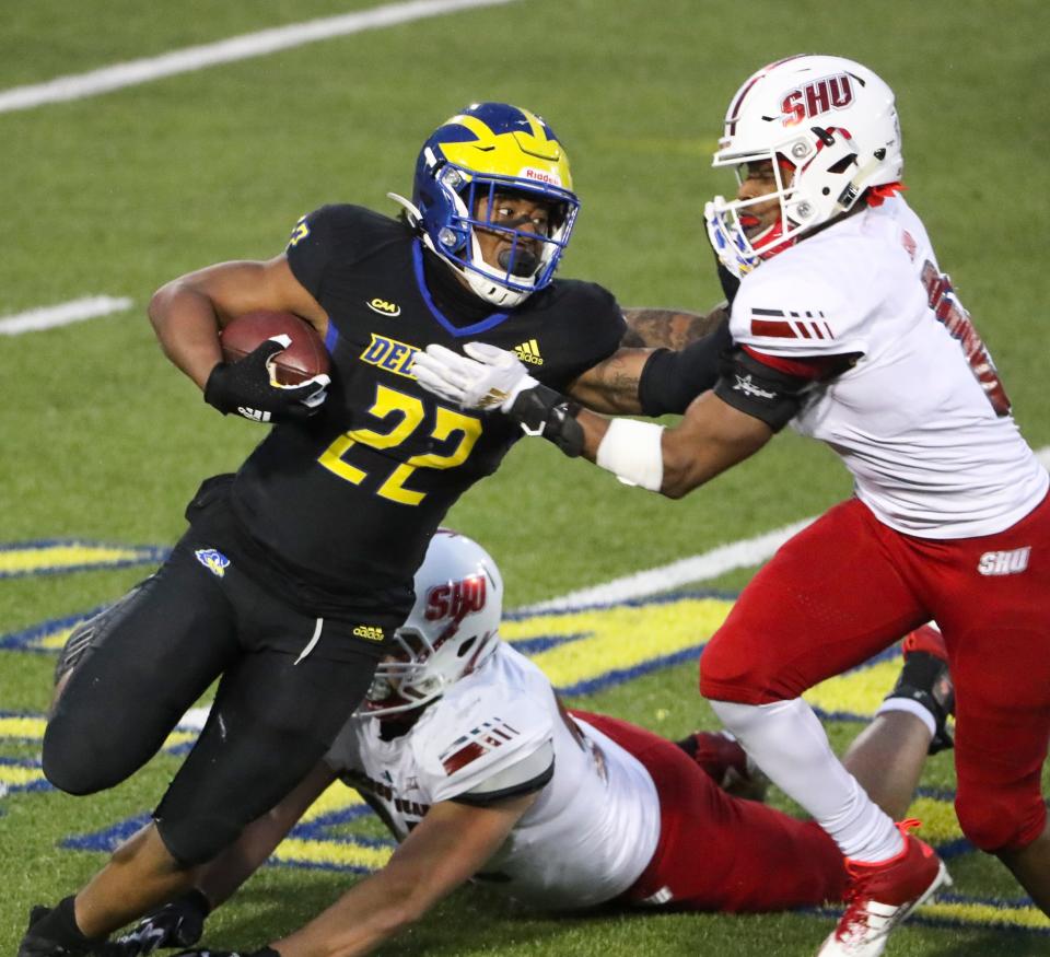 Delaware running back Khory Spruill tries to fend off Sacred Heart defenders including Chris Outterbridge (right) in the second quarter at Delaware Stadium in the opening round of the NCAA FCS tournament, Saturday, April 24, 2021.