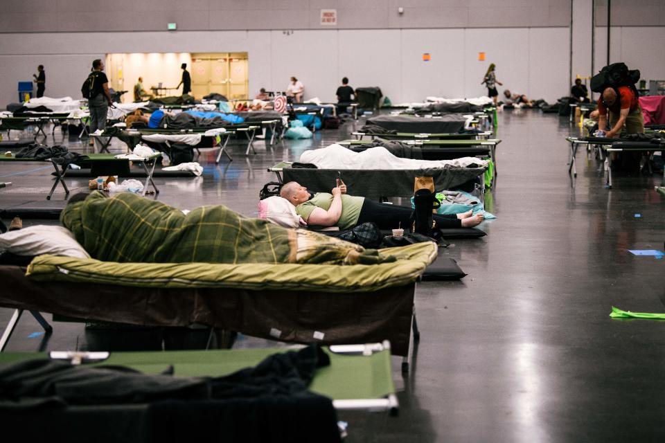 People rest at the Oregon Convention Center ‘cooling station’ during last month’s record heat (AFP via Getty Images)