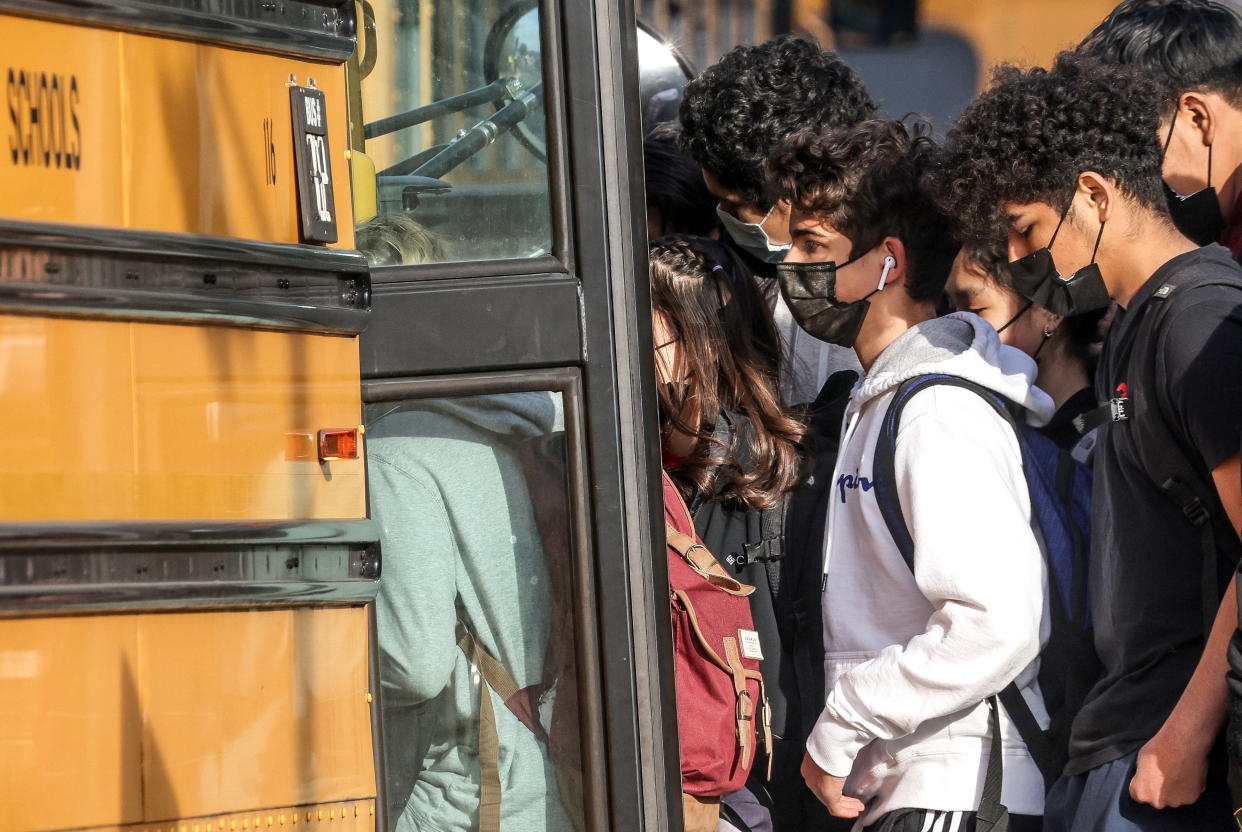 Students board a school bus outside of Washington-Liberty High School in Arlington County. (Credit: Evelyn Hockstein, REUTERS)