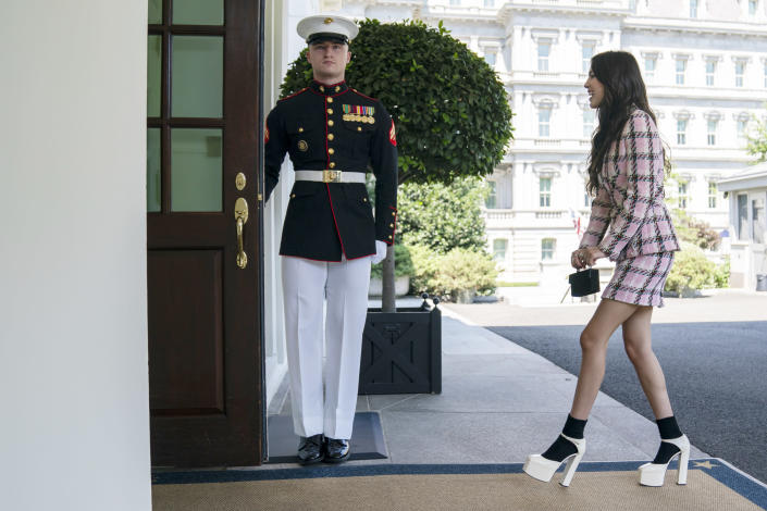 Olivia Rodrigo at the White House in July 2021 wearing a vintage Chanel skirt suit (with platforms) that has kept the coordinated mini set trend going through this summer. - Credit: AP