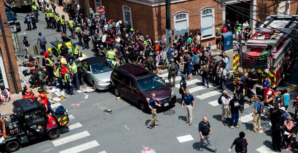 <p>People receive first-aid after a car accident ran into a crowd of protesters in Charlottesville, Va., on Aug. 12, 2017. (Photo: Paul J. Richards/AFP/Getty Images) </p>