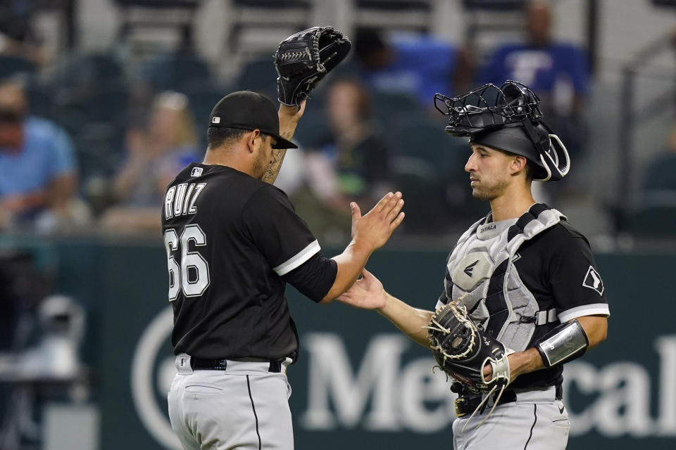 Chicago White Sox catcher Seby Zavala, right, congratulates closing pitcher Jose Ruiz (66) after the final out of the ninth inning of a baseball game against the Texas Rangers in Arlington, Texas, Sunday, Aug. 7, 2022. The White Sox won 8-2. (AP Photo/LM Otero)