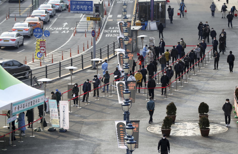 People queue in line to wait for coronavirus testing while maintaining social distancing at coronavirus testing site in Seoul, South Korea, Saturday, Dec. 26, 2020. (Hong Hyosik/Newsis via AP)
