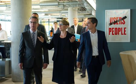 (L-R) German Interior Minister Thomas de Maiziere, Eva- Maria Kirschsieper, Facebook head of public policy D-A-CH and Martin Ott, Facebook managing director central Europe, walk during a vistit at the Facebook office in Berlin, Germany August 29, 2016. REUTERS/Stefanie Loos