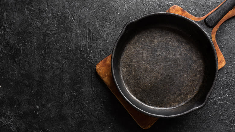 Cast iron skillet on wooden pan