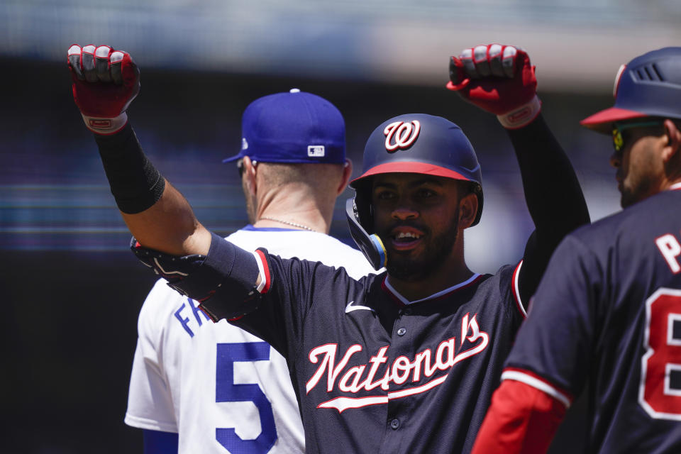 Washington Nationals' Luis Garcia Jr., center, celebrates after hitting a single during the first inning of a baseball game against the Los Angeles Dodgers, Wednesday, April 17, 2024, in Los Angeles. (AP Photo/Ryan Sun)