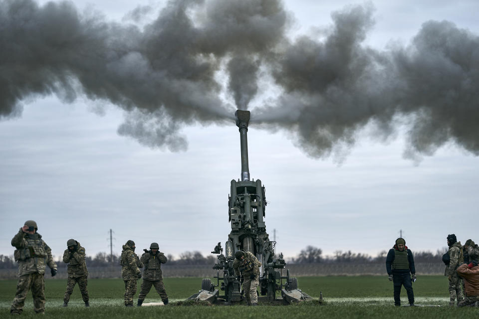 FILE - Ukrainian soldiers fire at Russian positions from a U.S.-supplied M777 howitzer in Kherson region, Ukraine, Jan. 9, 2023. War has been a catastrophe for Ukraine and a crisis for the globe. One year on, thousands of civilians are dead, and countless buildings have been destroyed. Hundreds of thousands of troops have been killed or wounded on each side. Beyond Ukraine’s borders, the invasion shattered European security, redrew nations’ relations with one another and frayed a tightly woven global economy. (AP Photo/Libkos, File)