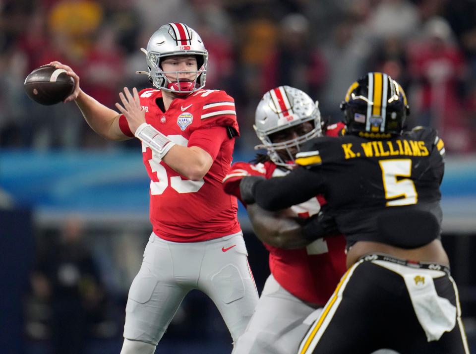 Dec 29, 2023; Arlington, Texas, USA; Ohio State Buckeyes quarterback Devin Brown (33) throws the ball against Missouri Tigers defense in the first quarter during the Goodyear Cotton Bowl Classic at AT&T Stadium. Credit: Kyle Robertson/Columbus Dispatch-USA TODAY NETWORK