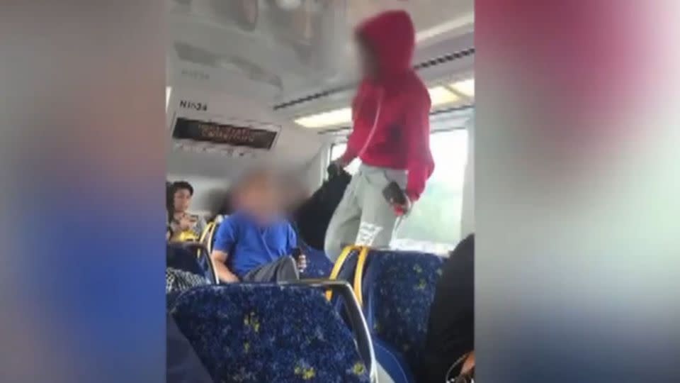 The woman walks across a row of chairs to get away from the man who sat next to her. Photo: Fairfax