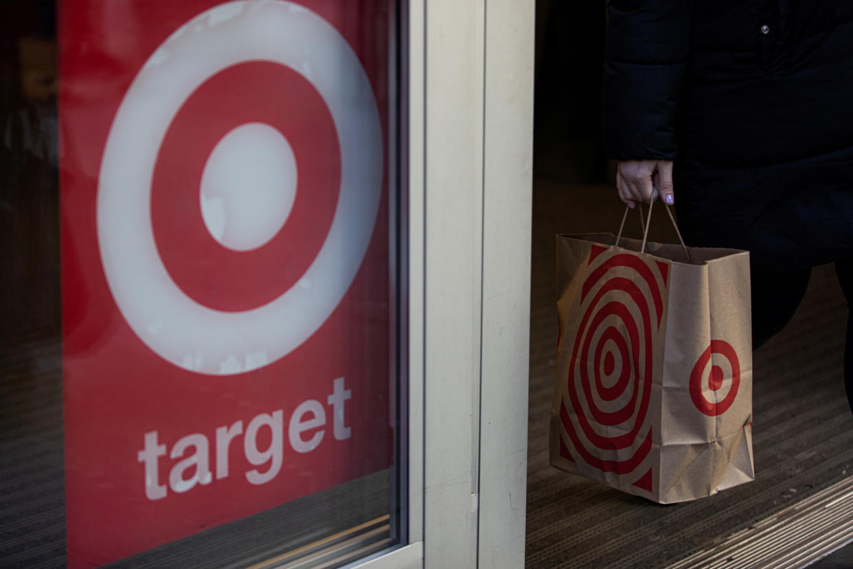 A shopper carries a Target paper bag in the Manhattan borough of New York City, New York, U.S., March 1, 2020. REUTERS/Jeenah Moon