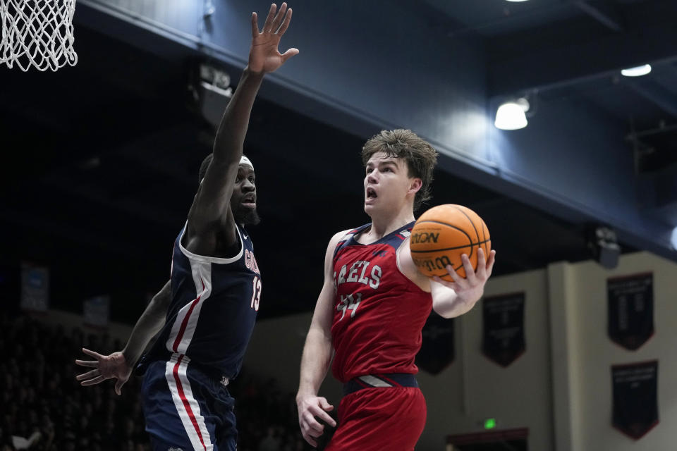 Saint Mary's guard Alex Ducas, right, shoots while defended by Gonzaga forward Graham Ike during the first half of an NCAA college basketball game Saturday, March 2, 2024, in Moraga, Calif. (AP Photo/Godofredo A. Vásquez)