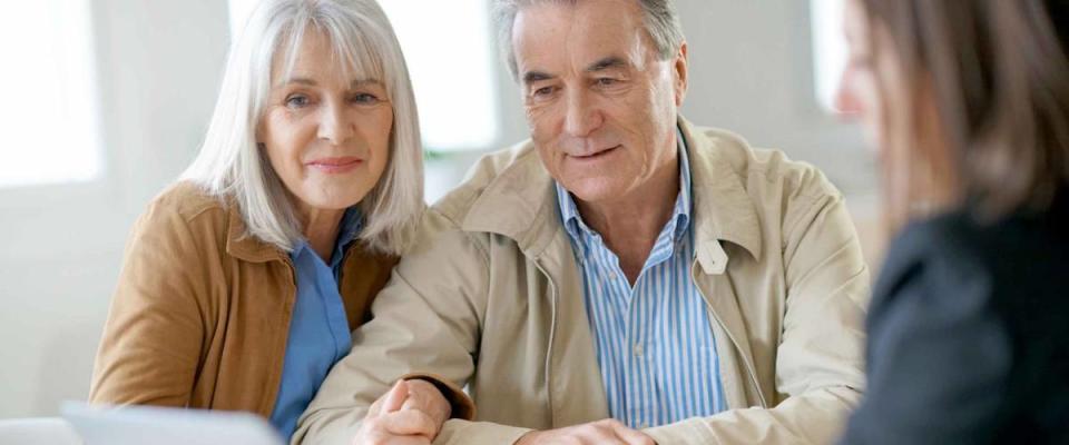 Senior couple meeting financial adviser for investment