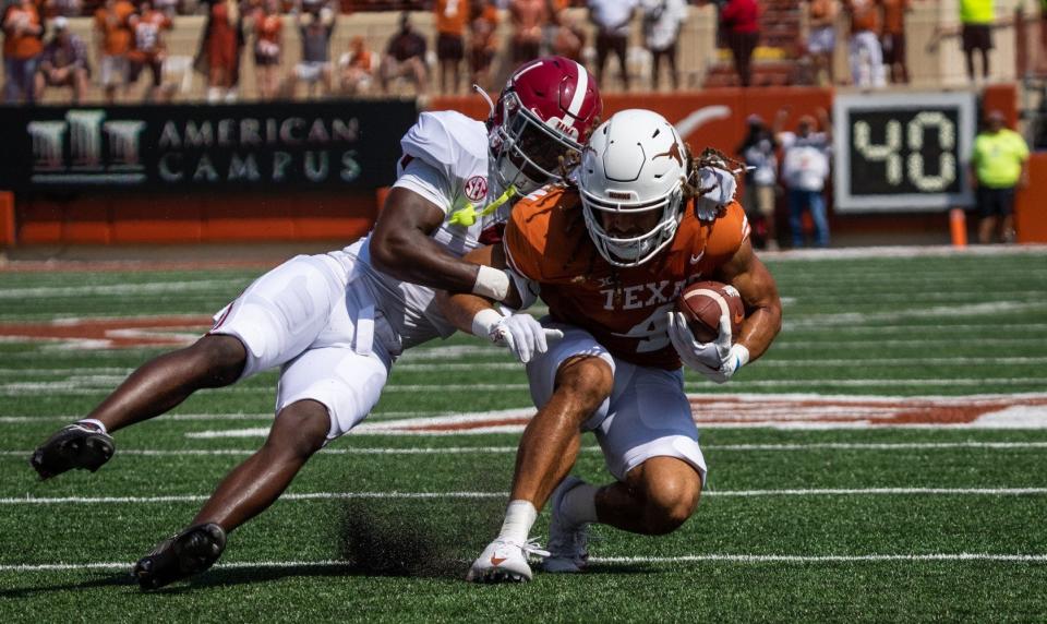 Texas receiver Jordan Whittington is tackled by an Alabama defender during the first half of last year's game in Austin. The Crimson Tide won 20-19. The teams' rematch will be Saturday in Tuscaloosa.