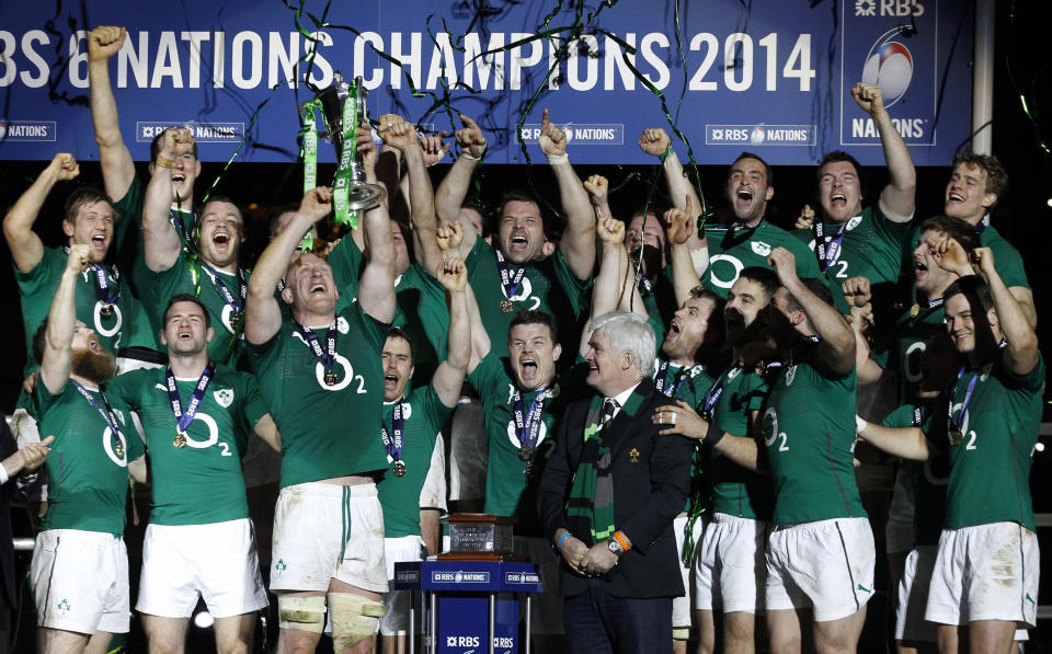 Ireland's rugby players celebrate after defeating France and winning the Six Nations Rugby Union tournament at the Stade de France stadium, in Saint Denis, outside Paris, Saturday, March 15, 2014. (AP Photo/Christophe Ena)