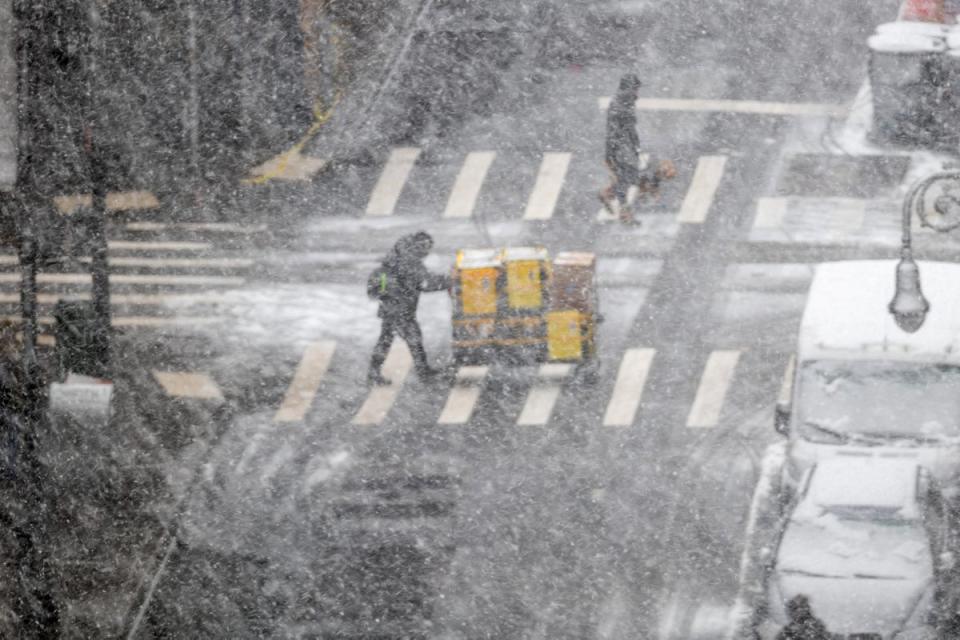 People walk through the blowing snow in Manhattan (Getty Images)